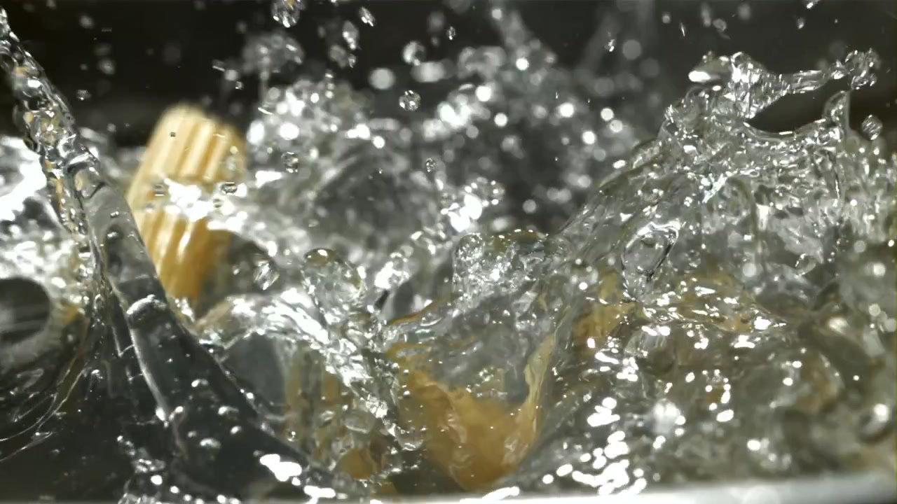 Penne Pasta Falling into Boiling Water in Slow Motion