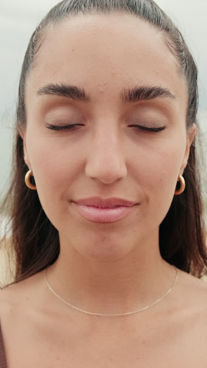 Serene Woman Smiles at Beach