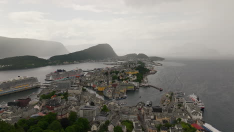 Misty-morning,-cityscape-scenery-foreground,-mountain-and-sea-backdrop