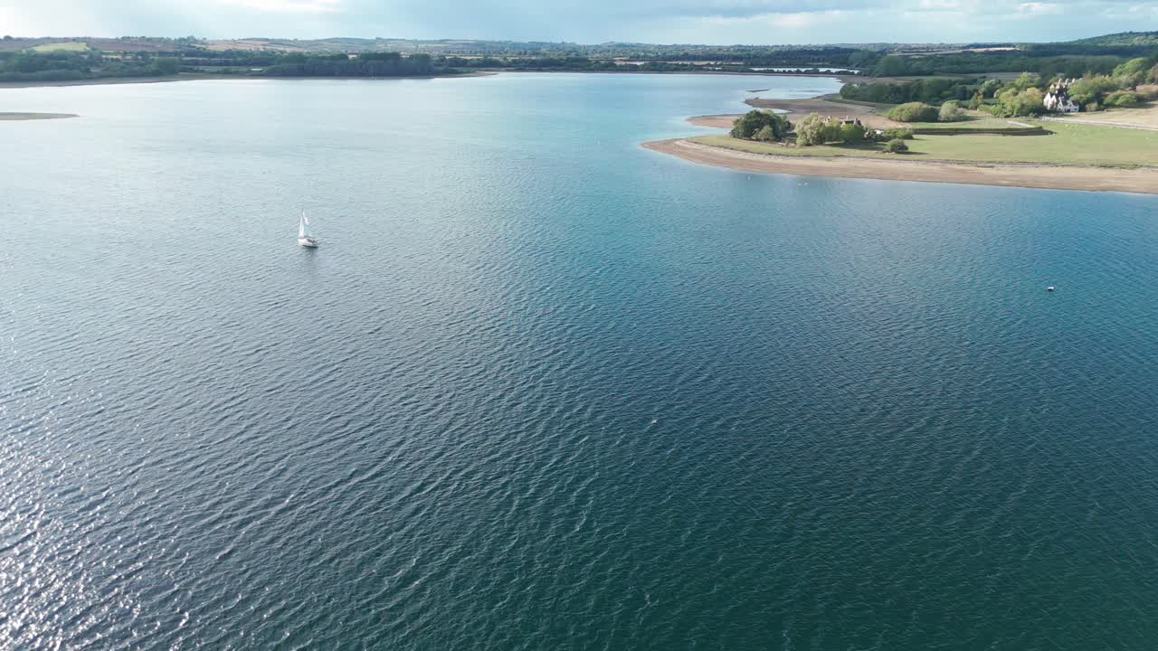 Aerial View of a Lake with a Sailboat