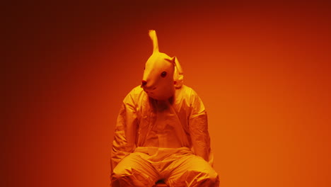 person in rabbit mask and hazmat suit