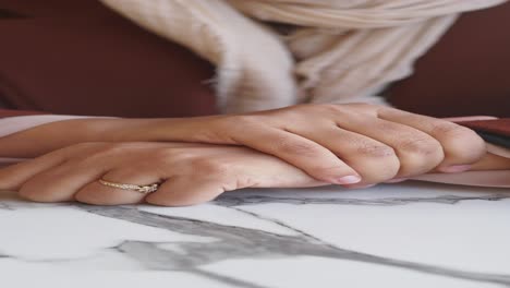 close up of a woman's hands with a gold ring