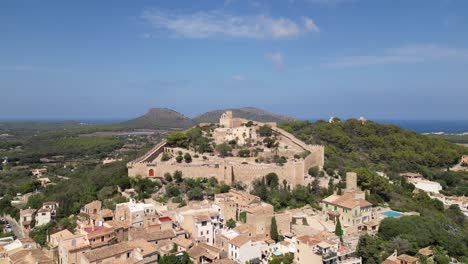 aerial view of a historic hilltop town with a castle