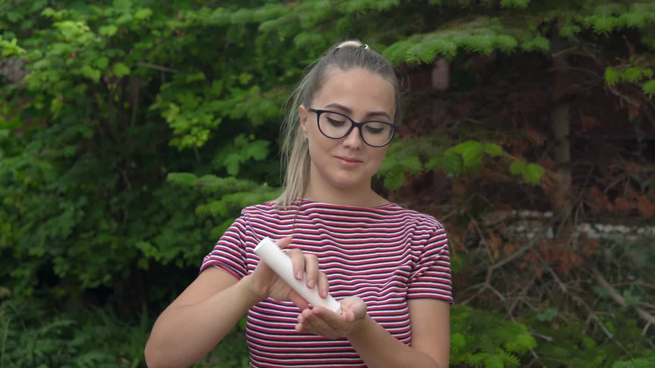 TA girl with glasses holds a capsule in her hand and takes out vitamins. Maintaining immunity. Healthy lifestyle. 4k