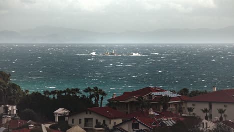 Meltem-stormy-winds-in-Aegean-basin-of-Turkey,-lighthouse-on-small-island-washed-by-waves-of-the-sea