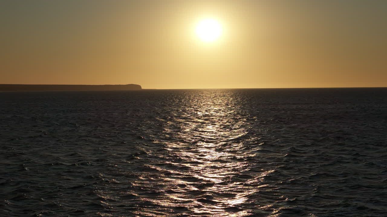 Ballena-franca-austral on the calm ocean horizon during sunset, Peninsula Valdes, Golfo Nuevo, Puerto Madryn, Argentina.