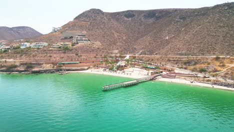 playa coromuel beach in la paz with turquoise water and hills, aerial view