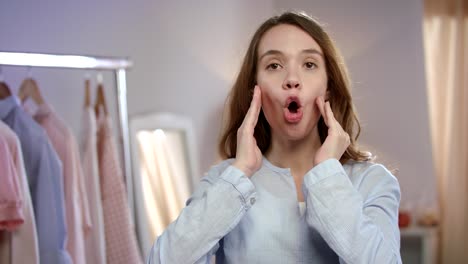 young woman doing facial exercise at home. joyful woman making face acupressure