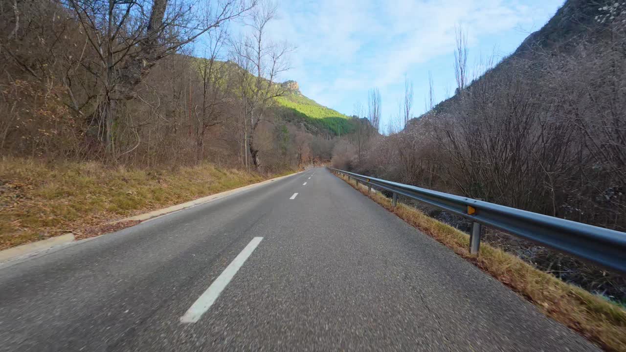 Road trip going up the mountain in the Pyrenees in Catalonia camera located in front of the car