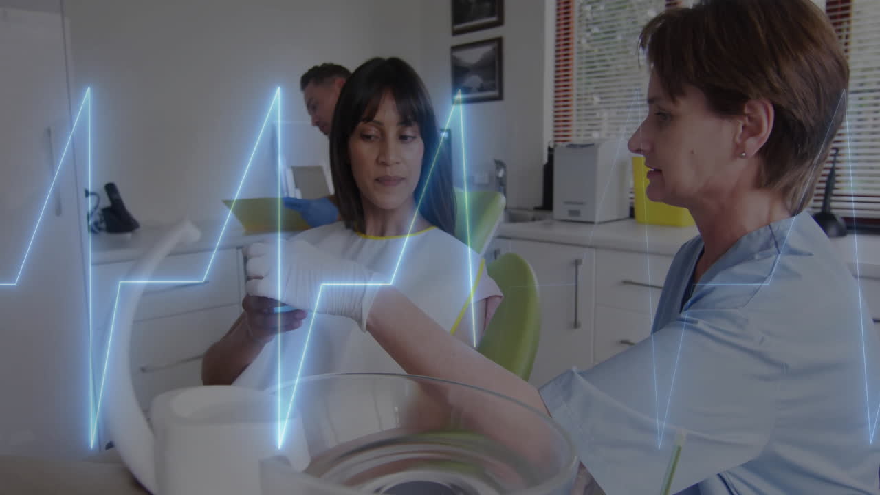 Heartbeat animation over medical professionals examining patient in clinic