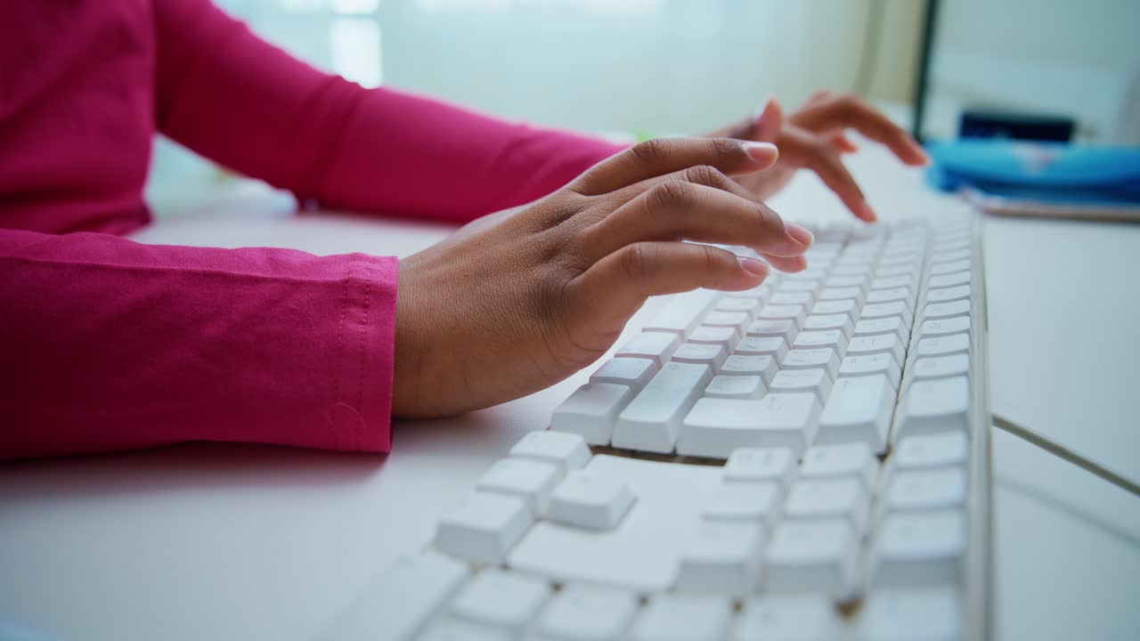 Female professional hands typing rapidly on white keyboard, showcasing efficient data entry and workplace communication skills at modern desk