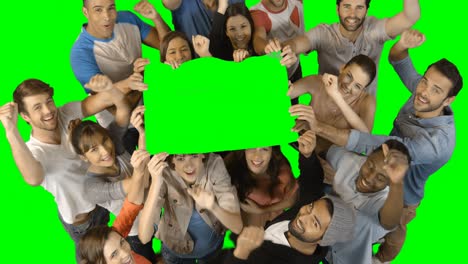 Overhead-view-of-excited-executives-holding-blank-green-placard