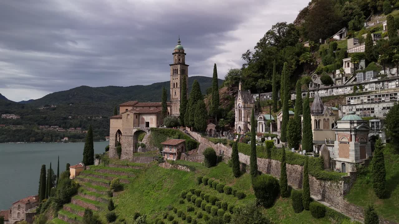 Stunning Aerial View of a Lake-Side Cemetery and Church in Italy