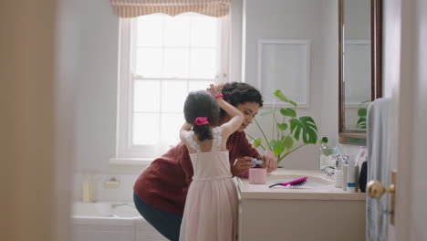happy-little-girl-brushing-mothers-hair-in-bathroom-mom-getting-daughter-ready-in-morning-enjoying-parenthood-caring-for-child