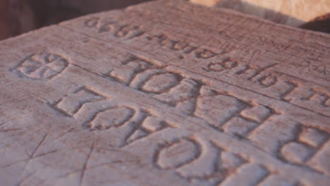 Close-up-of-ancient-ruins-in-Greece-with-symbols-and-writing