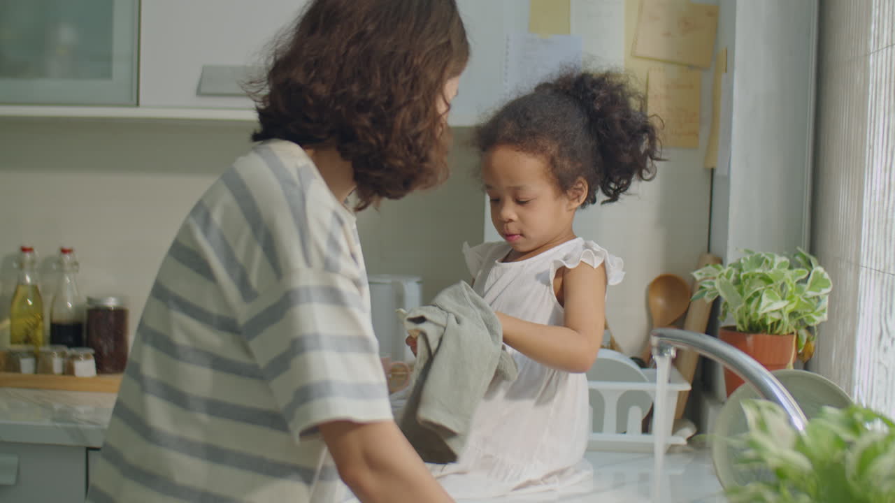 Asian Little Girl Helping Mom with Doing Dishes