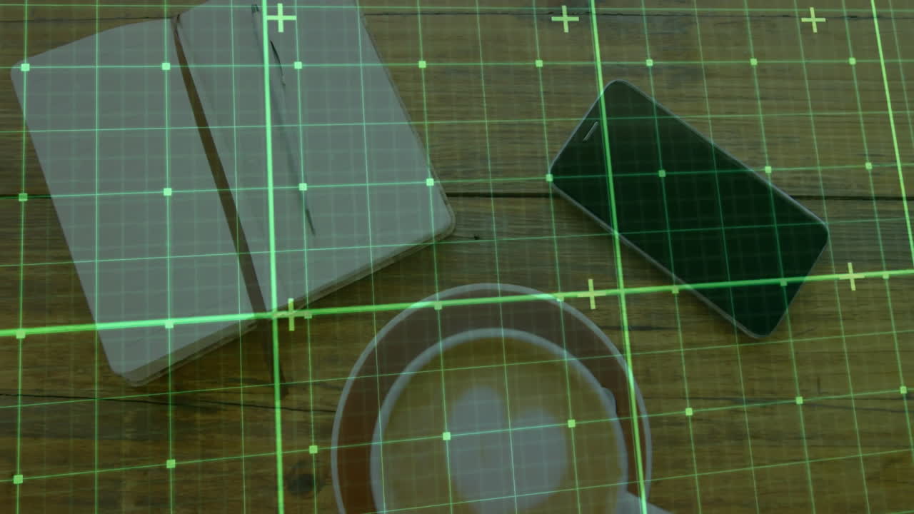 White coffee cup sitting on tabletop featuring notebook and phone under green grid