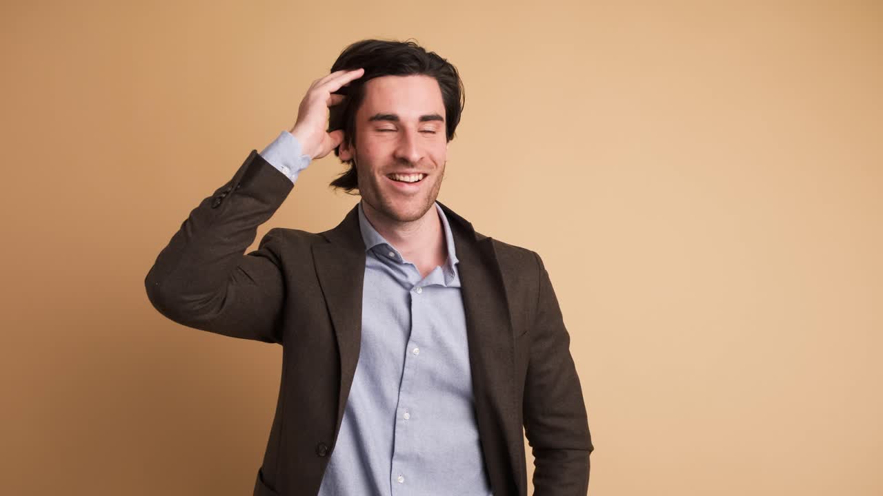 Stunned businessman with opened mouth in brown studio