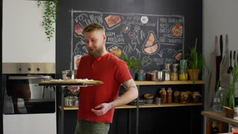 food blogger putting pizza in oven