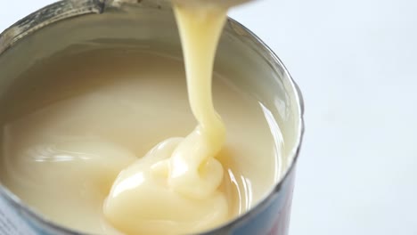 pouring condensed milk from a can