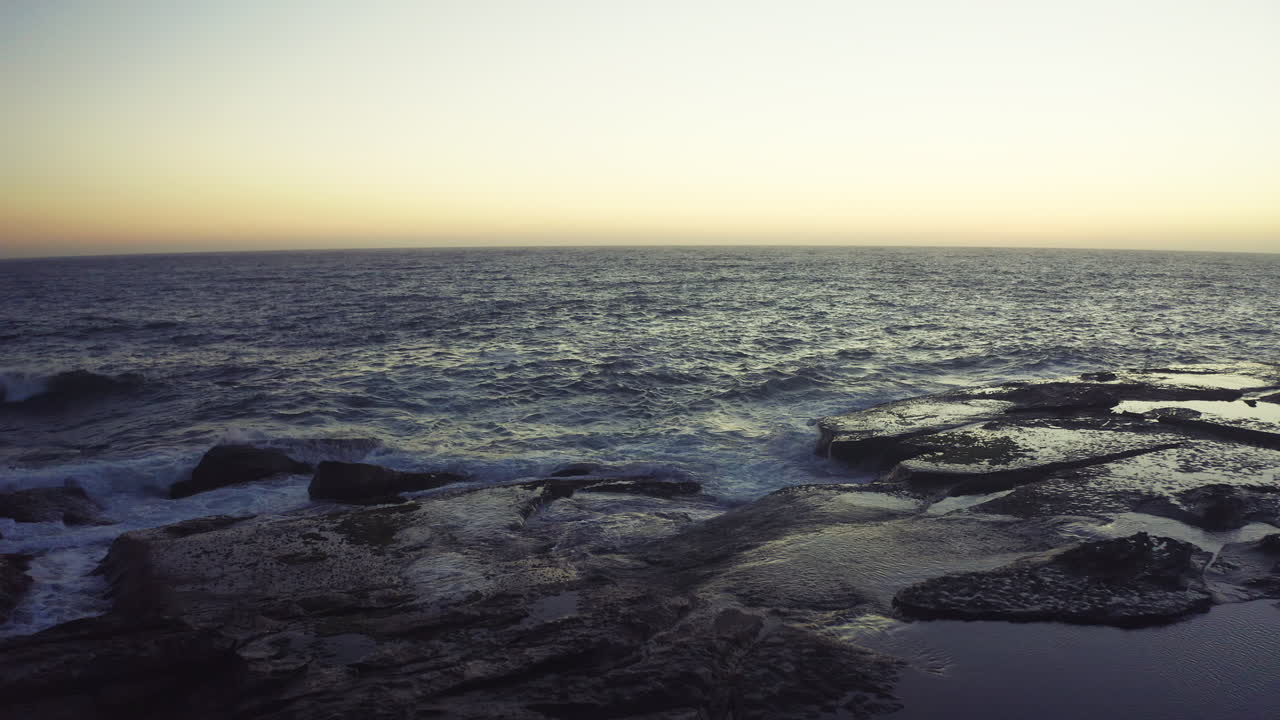 puesta o amanecer costera sobre la orilla rocosa