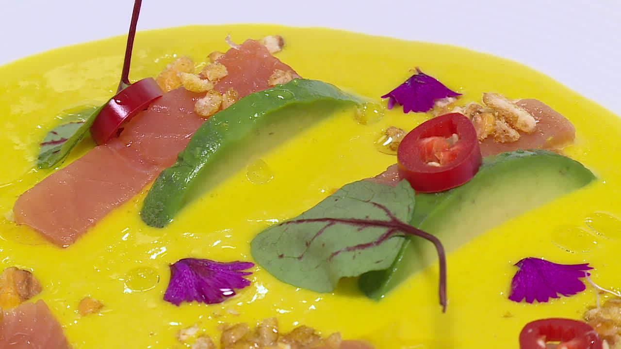 Salmon and Avocado Dish on a Yellow Creamy Sauce