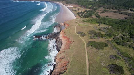 boulder beach - lennox heads - new south wales - australia - slow lift and reveal aerial shot