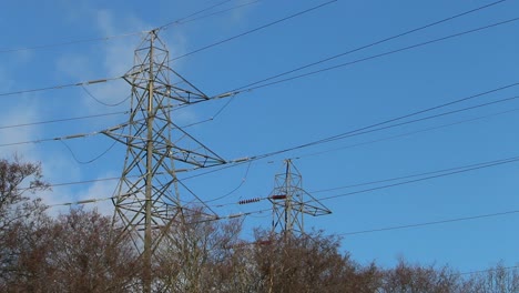 electricity pylons against a blue sky. winter. uk