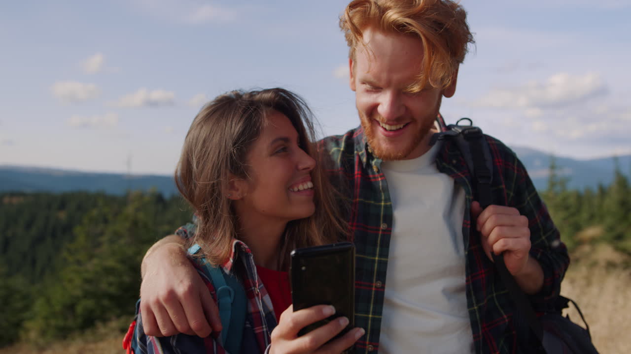 Man and woman looking at smartphone screen