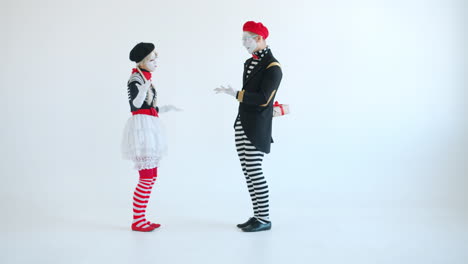 mime couple exchanging a gift