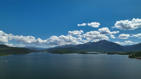 aerial cinematic drone breckenridge ski resort mountain wide motorboats sailing lake dillon colorado 9 mile range summer blue sky beautiful daytime frisco silverthorne reservoir circle left motion