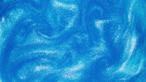 light blue glittering liquid swirling