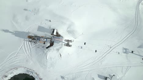 Tourists-and-adventure-seekers-on-a-cable-ride-for-sightseeing-at-the-snowy-sloped-of-Engelberg,-located-in-Brunni,-Switzerland