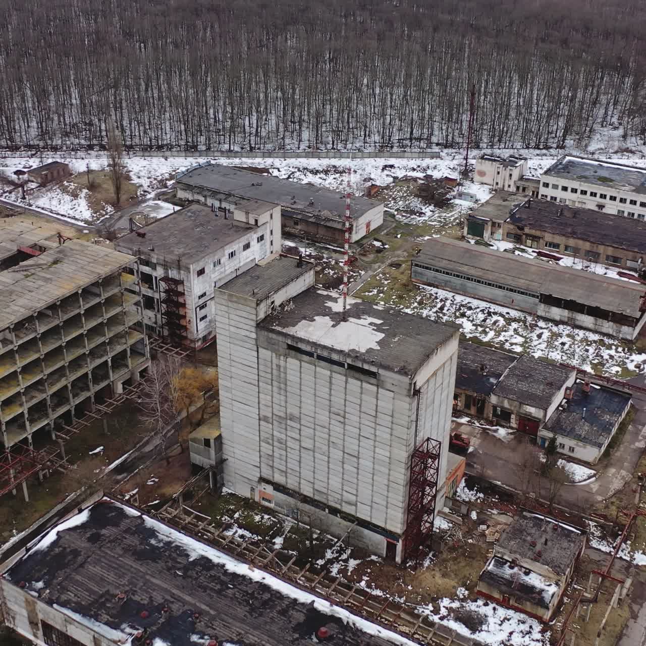 Damaged industrial plant. Old factory with abandoned buildings. Desolate place after the military actions. View from above