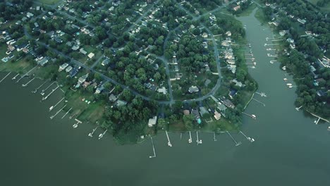 birdseye aerial view on picturesque coast of kent island, docks and upscale houses in twilight