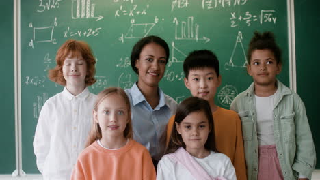 Teacher-and-pupils-posing-for-camera.