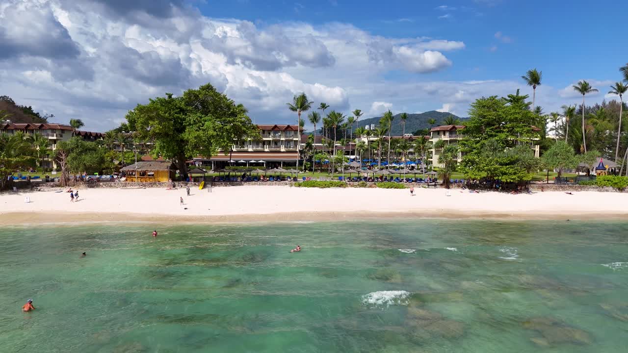 Drone footage showcasing a luxury beach resort in Phuket, Thailand, highlighting its pool, lush surroundings, and beachfront location