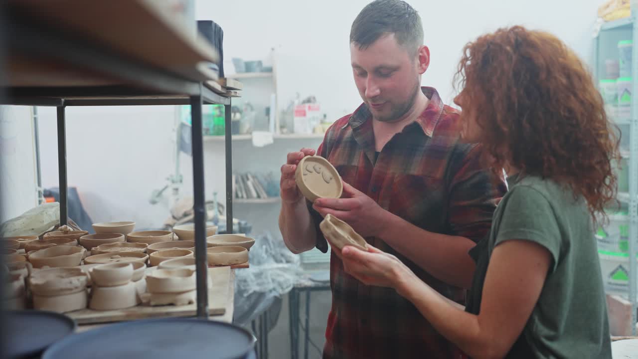 Potters Examining Clay Bowls in Workshop