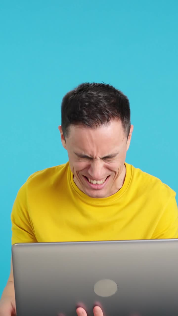 Man celebrating success on laptop