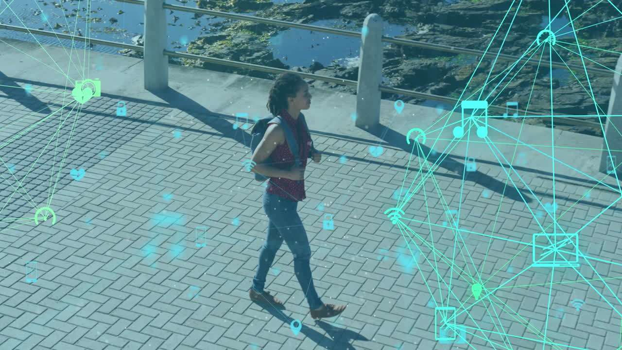 Animation of network of connections with technological icons over woman walking on park