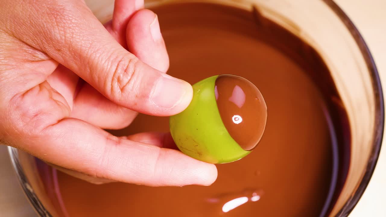 Grape dipped in chocolate by hand