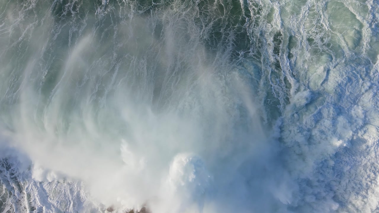 Powerful Ocean Waves Creating Foamy Patterns - Aerial Top Down, Slow Motion