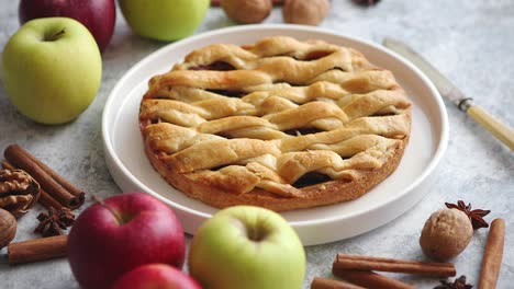 Tasty-sweet-homemade-apple-pie-cake-with-cinnamon-sticks--walnuts-and-apples