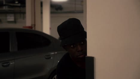 young black man spying in the parking lot