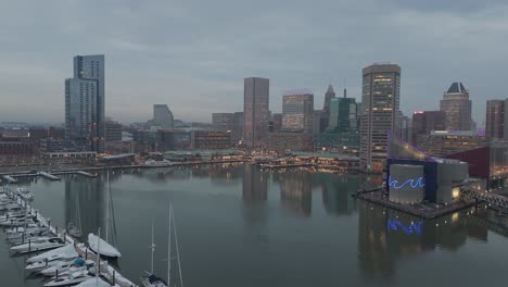 inner harbor and skyline drone reveal shot at dusk, overcast weather