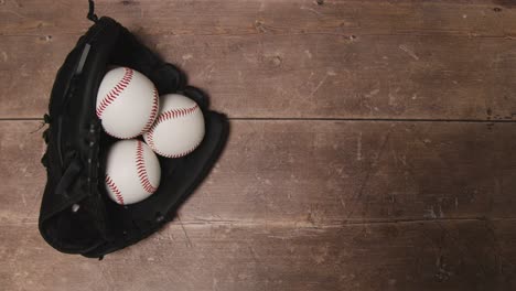 overhead studio baseball still life with balls in catchers mitt on wooden floor 1