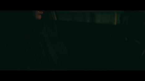 Person driving at night with playing cards in hand