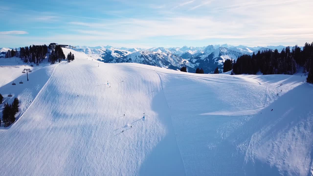 Ski in the Alps with ski lift and people skiing on the slope
