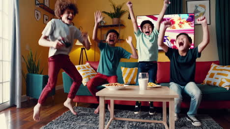 boys playing and celebrating victory in a video game