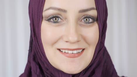 portrait of muslim woman. he is looking at the camera and smiling.